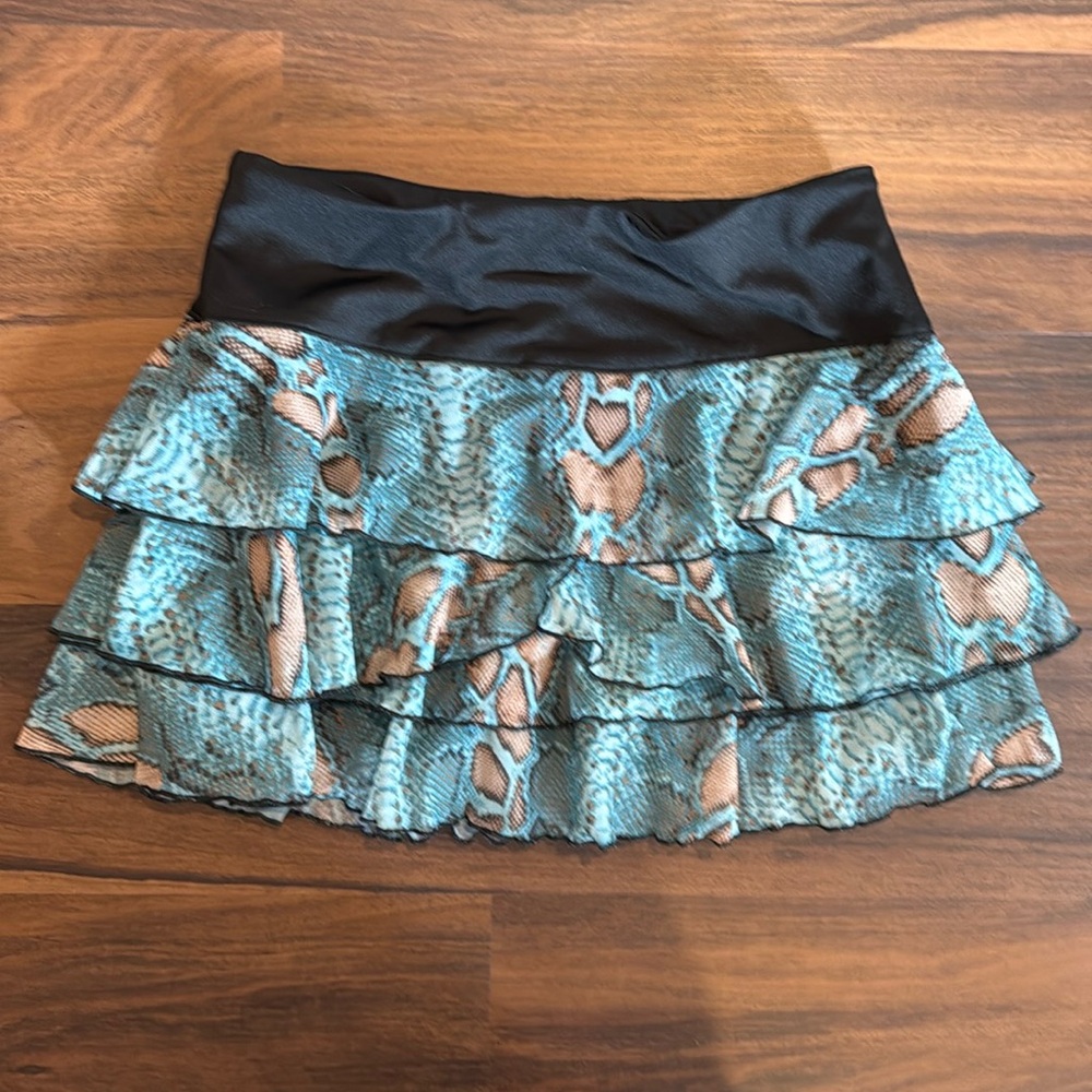 Peachy Tan tennis skort.Built in black spandex shorts. Mesh animal print. Size S